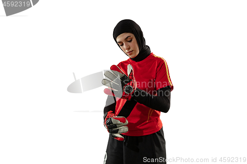 Image of Arabian female soccer or football player, goalkeeper on white studio background