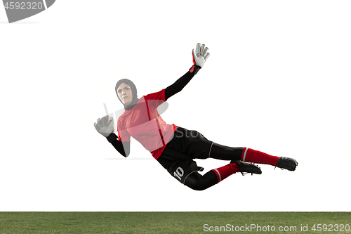 Image of Arabian female soccer or football player, goalkeeper on white studio background