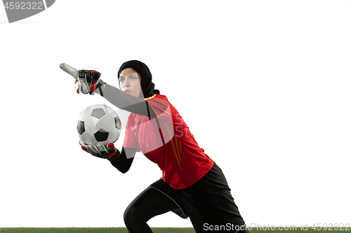 Image of Arabian female soccer or football player, goalkeeper on white studio background