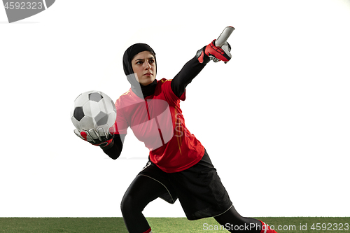 Image of Arabian female soccer or football player, goalkeeper on white studio background