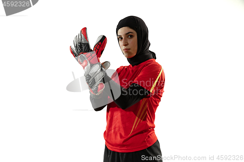 Image of Arabian female soccer or football player, goalkeeper on white studio background