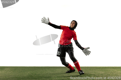 Image of Arabian female soccer or football player, goalkeeper on white studio background