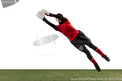 Image of Arabian female soccer or football player, goalkeeper on white studio background