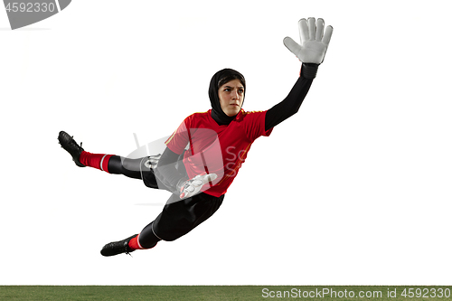 Image of Arabian female soccer or football player, goalkeeper on white studio background