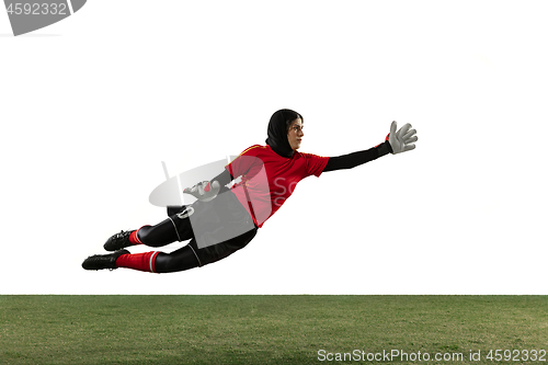 Image of Arabian female soccer or football player, goalkeeper on white studio background