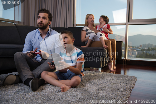 Image of Happy family playing a video game