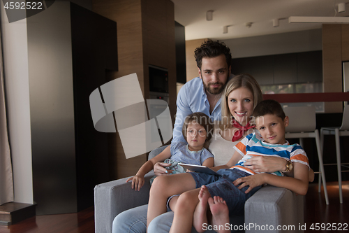 Image of happy young couple spending time with kids