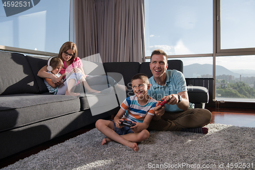 Image of Happy family playing a video game