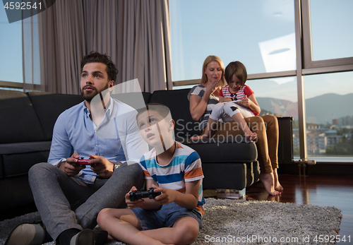 Image of Happy family playing a video game