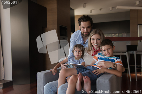 Image of happy young couple spending time with kids