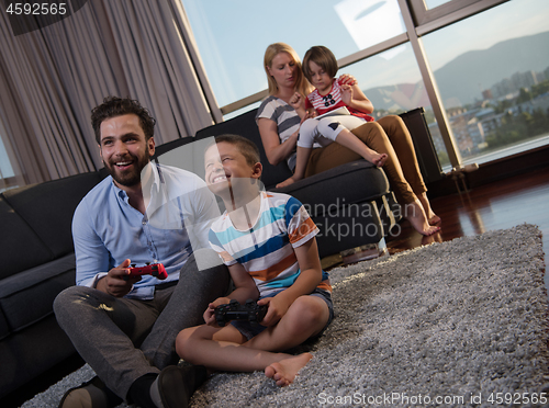 Image of Happy family playing a video game