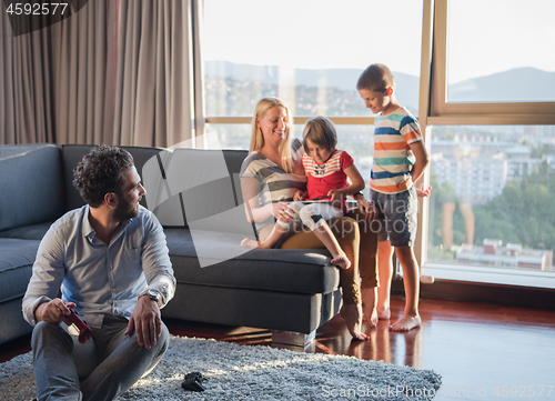 Image of Happy family playing a video game