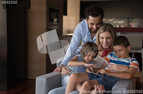 Image of happy young couple spending time with kids