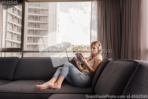 Image of young girl enjoying music through headphones