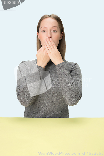 Image of Young woman covering her mouth