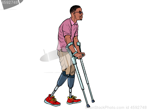 Image of legless african veteran with a bionic prosthesis with crutches. a disabled man learns to walk after an injury. rehabilitation treatment and recovery