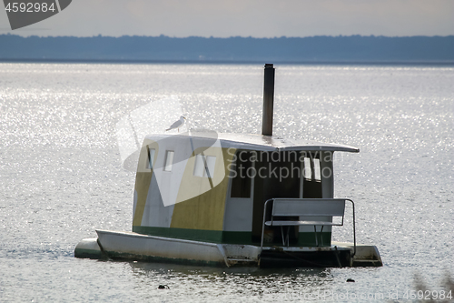 Image of Floating sauna with seagul in the sea.