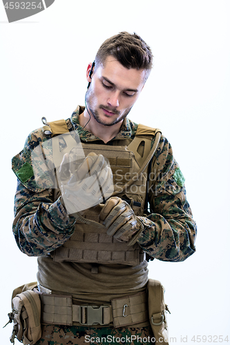 Image of closeup of soldier hands putting protective battle gloves