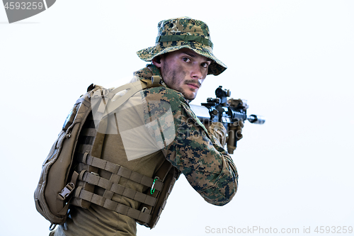 Image of soldier in action aiming laseer sight optics