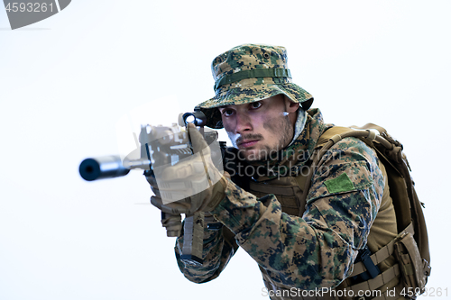 Image of soldier in action aiming laseer sight optics