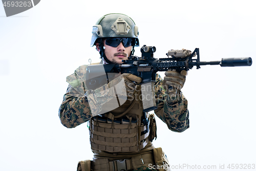 Image of soldier in action aiming laseer sight optics