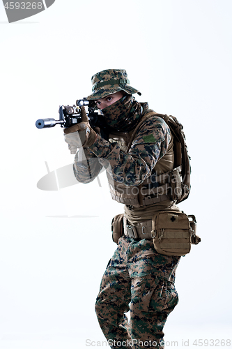 Image of soldier in action aiming laseer sight optics