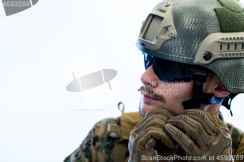 Image of soldier preparing gear for action