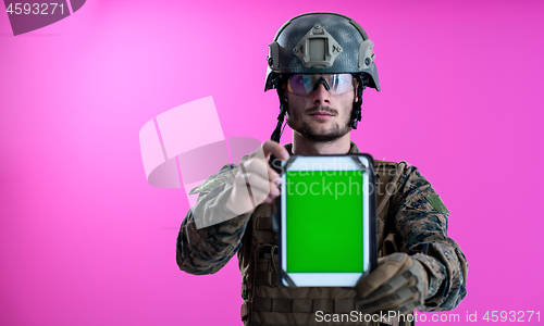 Image of soldier showing a tablet with a blank green screen