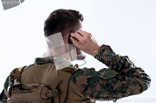 Image of soldier preparing gear for action and checking communication