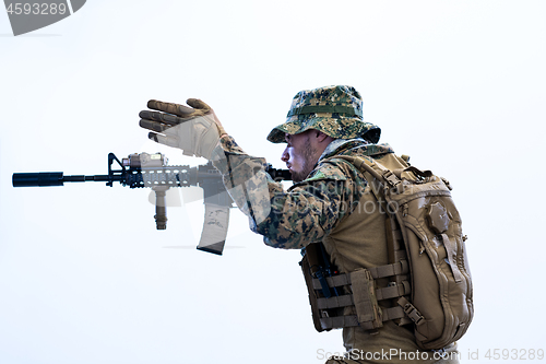 Image of soldier in action aiming laseer sight optics