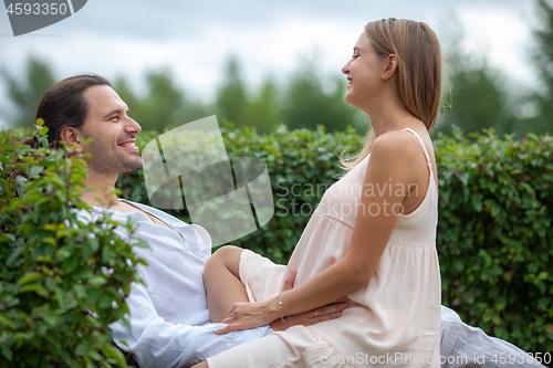 Image of happy young man and pregnant woman