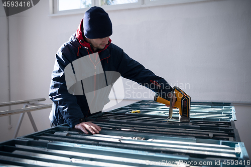 Image of team of mining  workers measuring drilled rock core