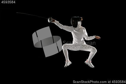 Image of Teen girl in fencing costume with sword in hand isolated on black background