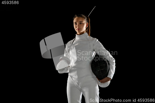 Image of Teen girl in fencing costume with sword in hand isolated on black background