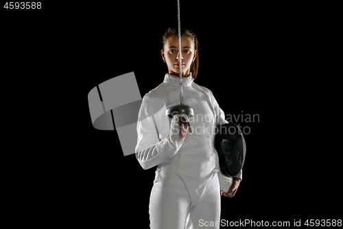 Image of Teen girl in fencing costume with sword in hand isolated on black background