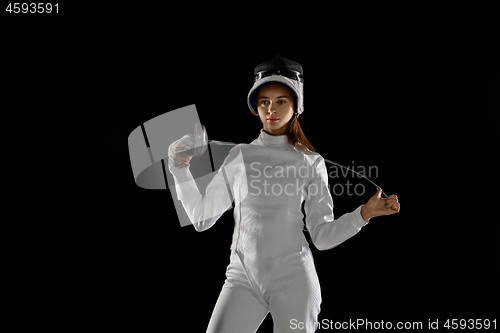 Image of Teen girl in fencing costume with sword in hand isolated on black background