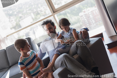 Image of happy young father spending time with kids