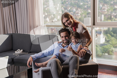 Image of happy young couple spending time with kids