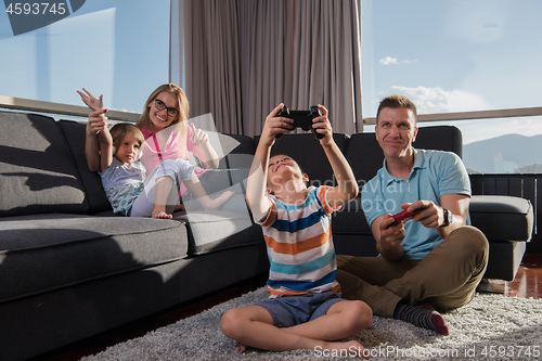 Image of Happy family playing a video game