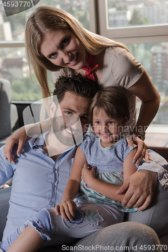 Image of happy young couple spending time with kids