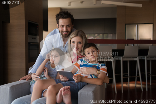 Image of happy young couple spending time with kids