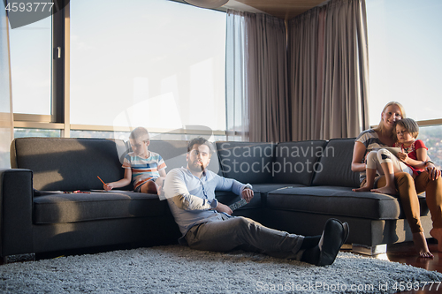 Image of Happy Young Family Playing Together on sofa