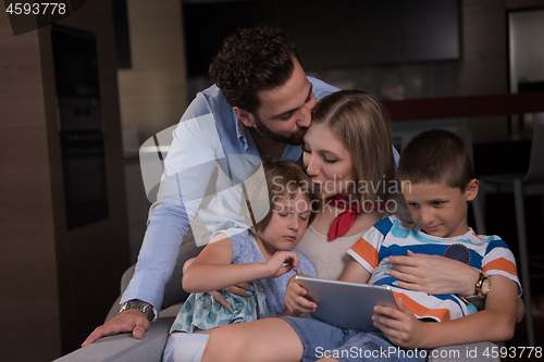 Image of happy young couple spending time with kids