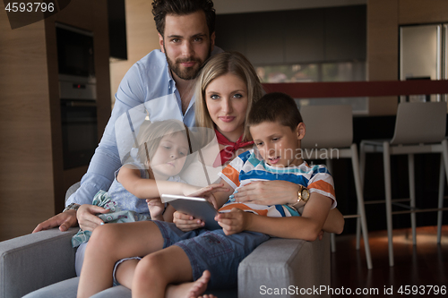 Image of happy young couple spending time with kids