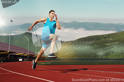 Image of man running in the track. Fit male fitness runner jogging in stadium