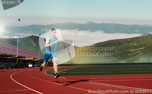 Image of man running in the track. Fit male fitness runner jogging in stadium
