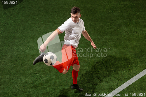 Image of Football player tackling ball over green grass background