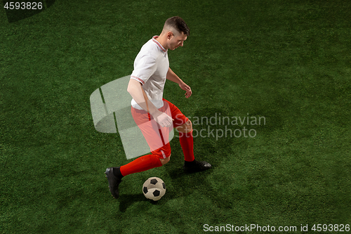 Image of Football player tackling ball over green grass background