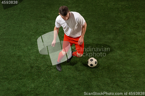 Image of Football player tackling ball over green grass background