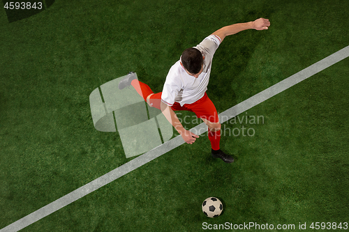 Image of Football player tackling ball over green grass background